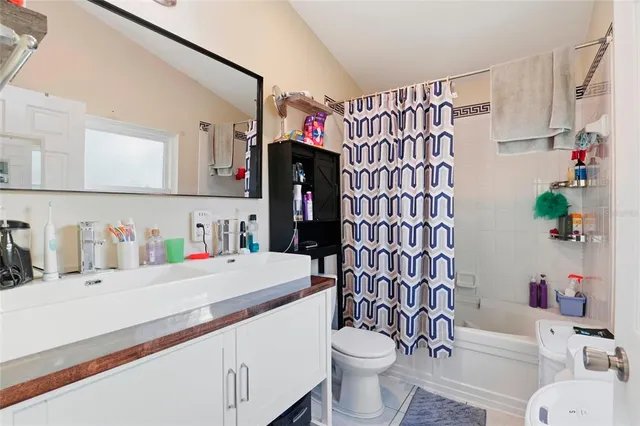 a bathroom with a sink mirror toilet and shower