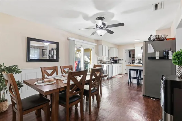a view of a dining room with furniture and wooden floor