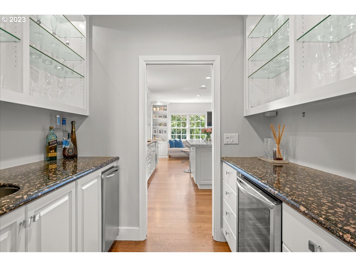 7470 Southwest Westgate Way Portland, OR 97225 - Photo 13 of 41 a kitchen with kitchen island granite countertop a sink a stove and cabinets