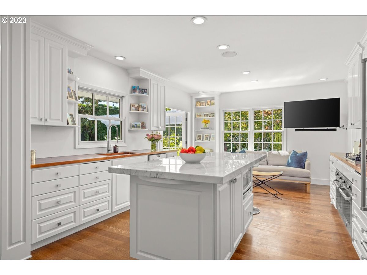 7470 Southwest Westgate Way Portland, OR 97225 - Photo 15 of 41 a kitchen with stainless steel appliances kitchen island granite countertop a sink and cabinets