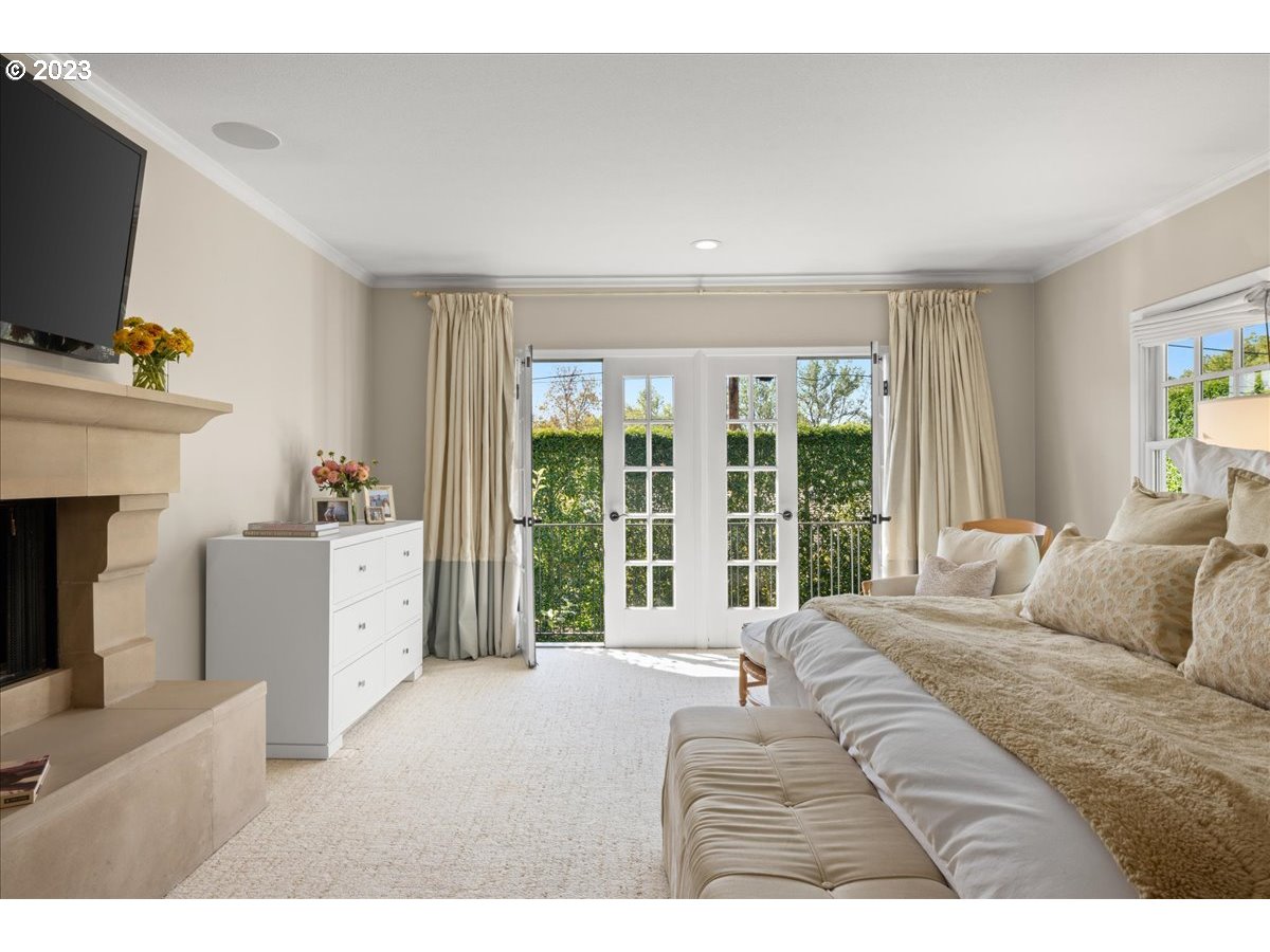 7470 Southwest Westgate Way Portland, OR 97225 - Photo 25 of 41 a spacious bedroom with a large bed and a flat screen tv