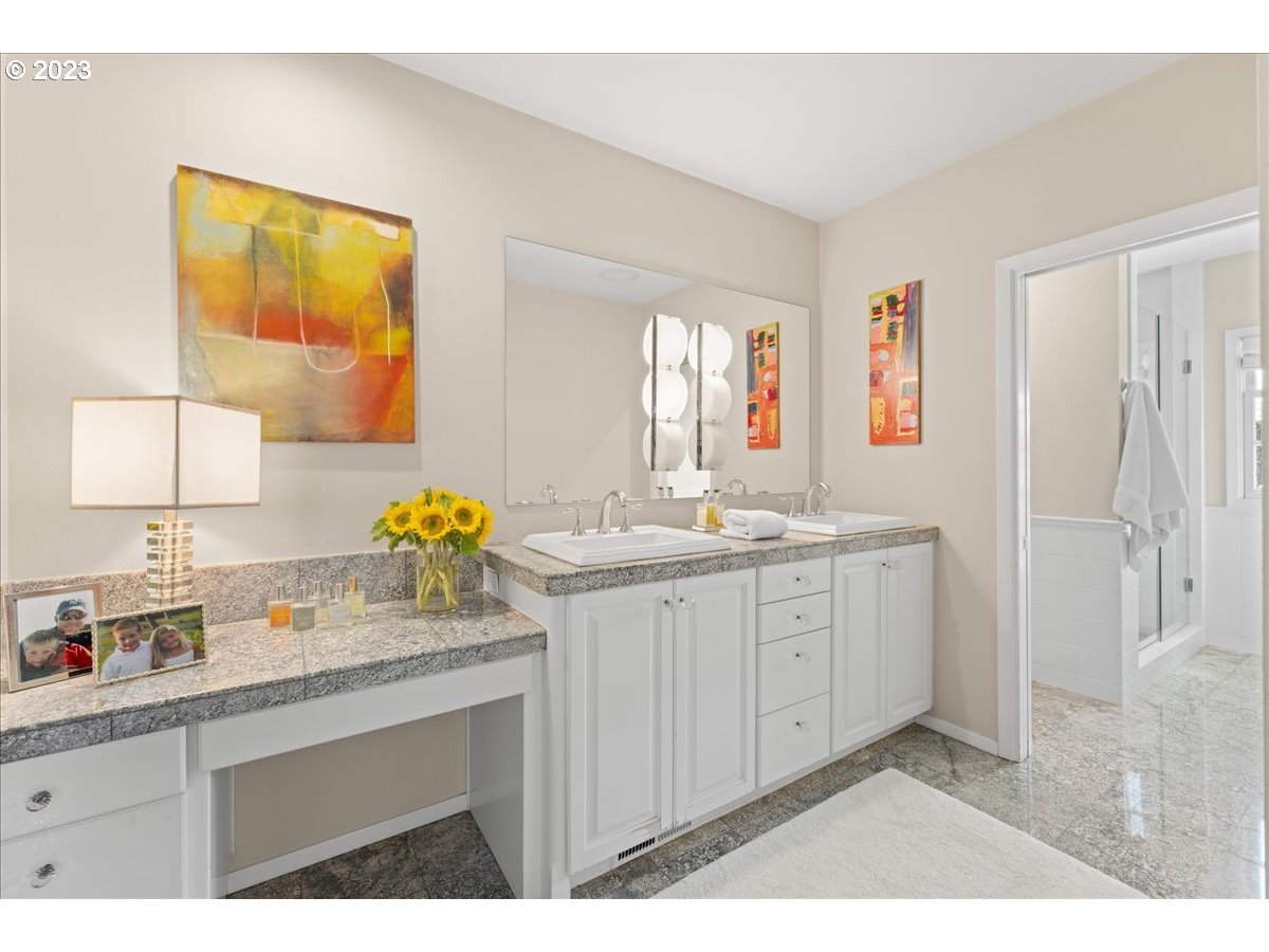 7470 Southwest Westgate Way Portland, OR 97225 - Photo 27 of 41 a bathroom with a sink double vanity granite and a mirror