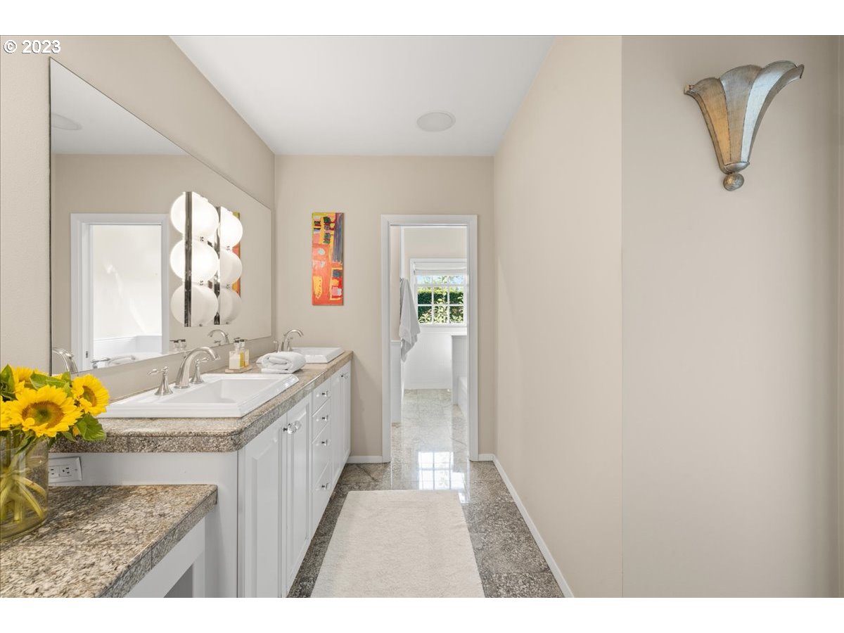 7470 Southwest Westgate Way Portland, OR 97225 - Photo 28 of 41 a bathroom with a granite countertop sink a toilet and a mirror