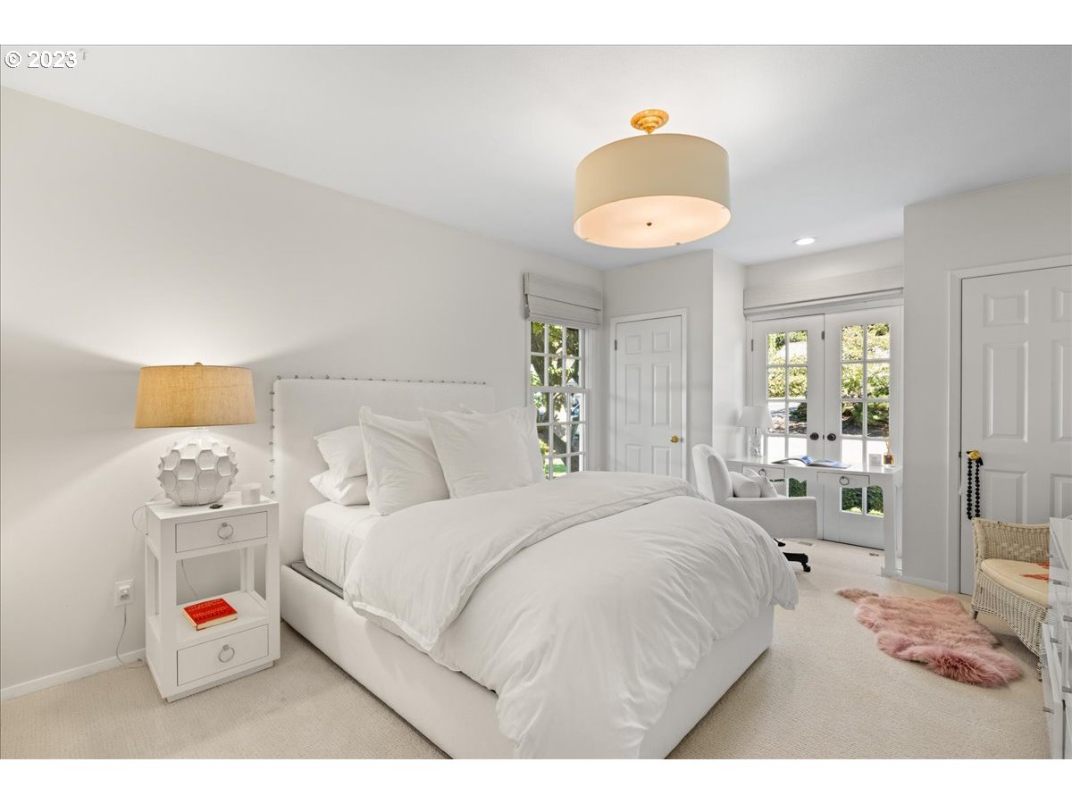 7470 Southwest Westgate Way Portland, OR 97225 - Photo 29 of 41 a bedroom with a bed and a chandelier