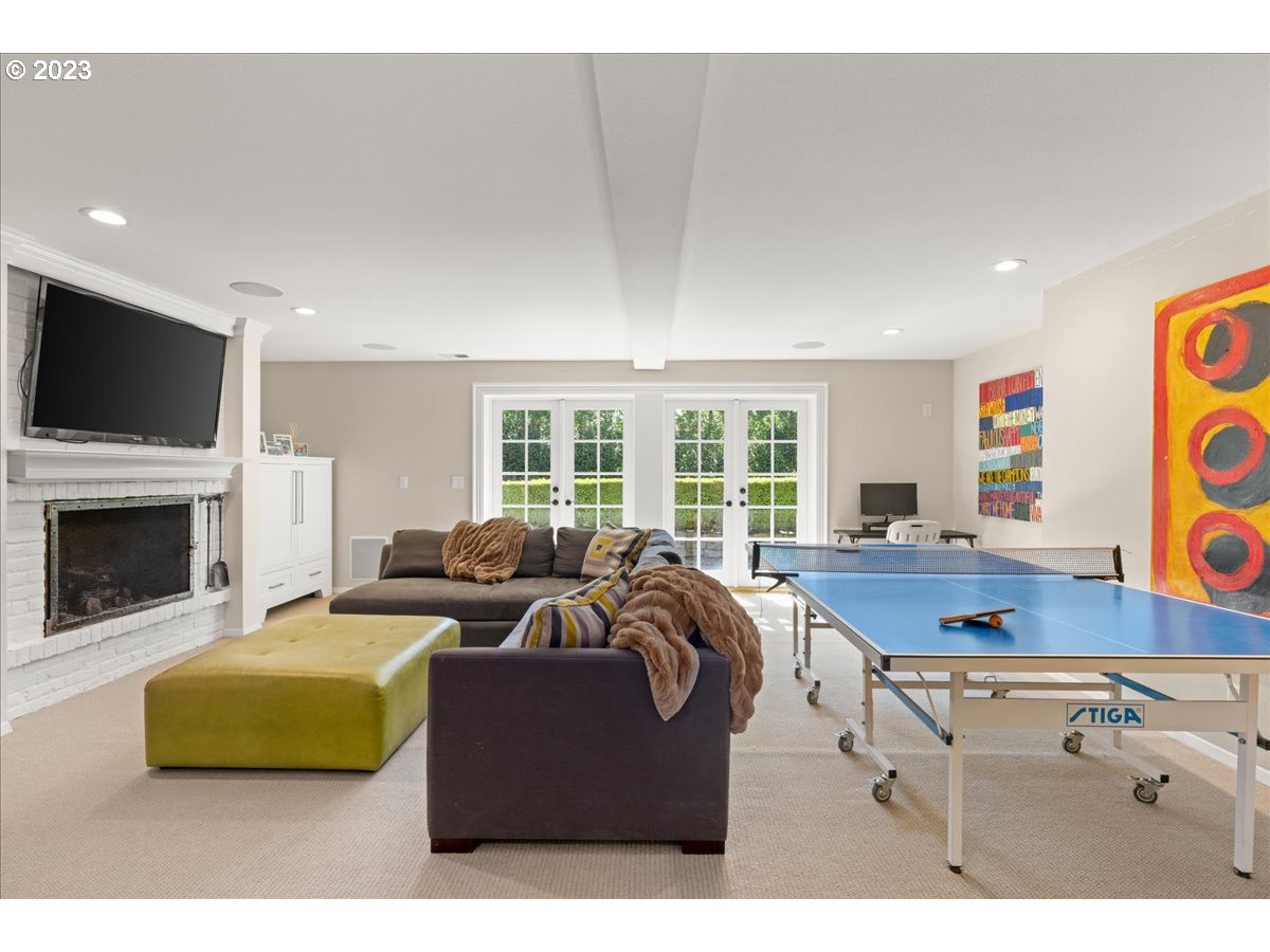 7470 Southwest Westgate Way Portland, OR 97225 - Photo 32 of 41 a living room with furniture flat screen tv and a fireplace