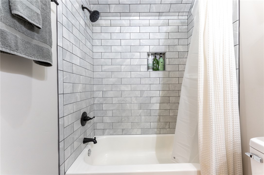 103 Riggs Drive Clemson, SC 29631 - Photo 45 of 50 A pristine bath and shower area features modern tilework and sleek black fixtures.