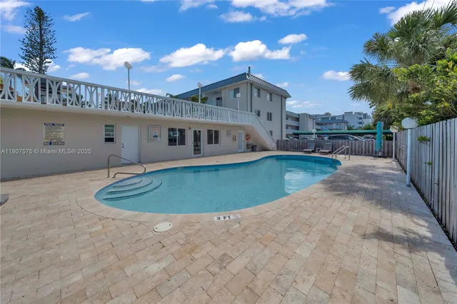 a view of a house with a swimming pool and a yard