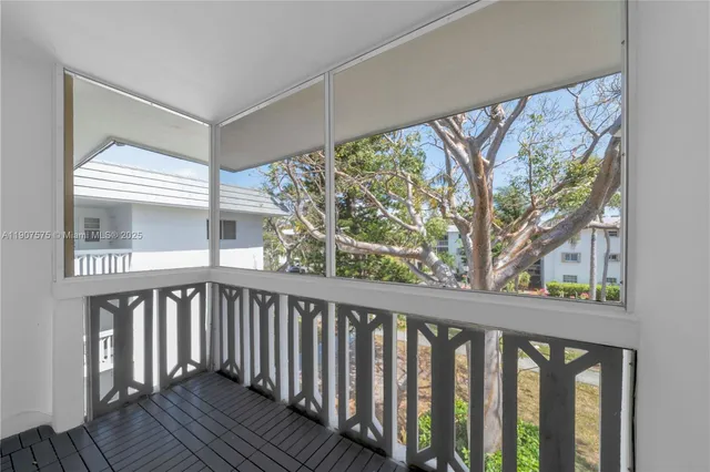 a view of a balcony with wooden floor