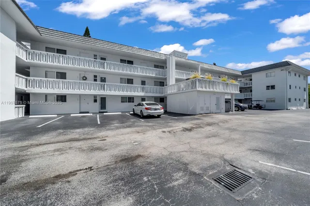 a view of building with parking area