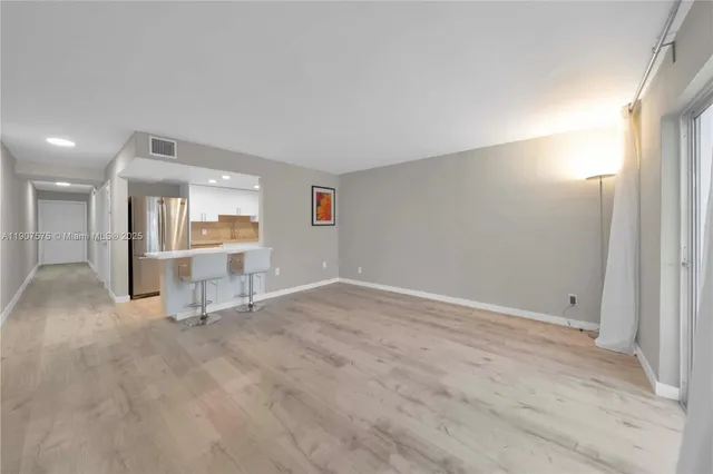 an empty room with a empty space and windows