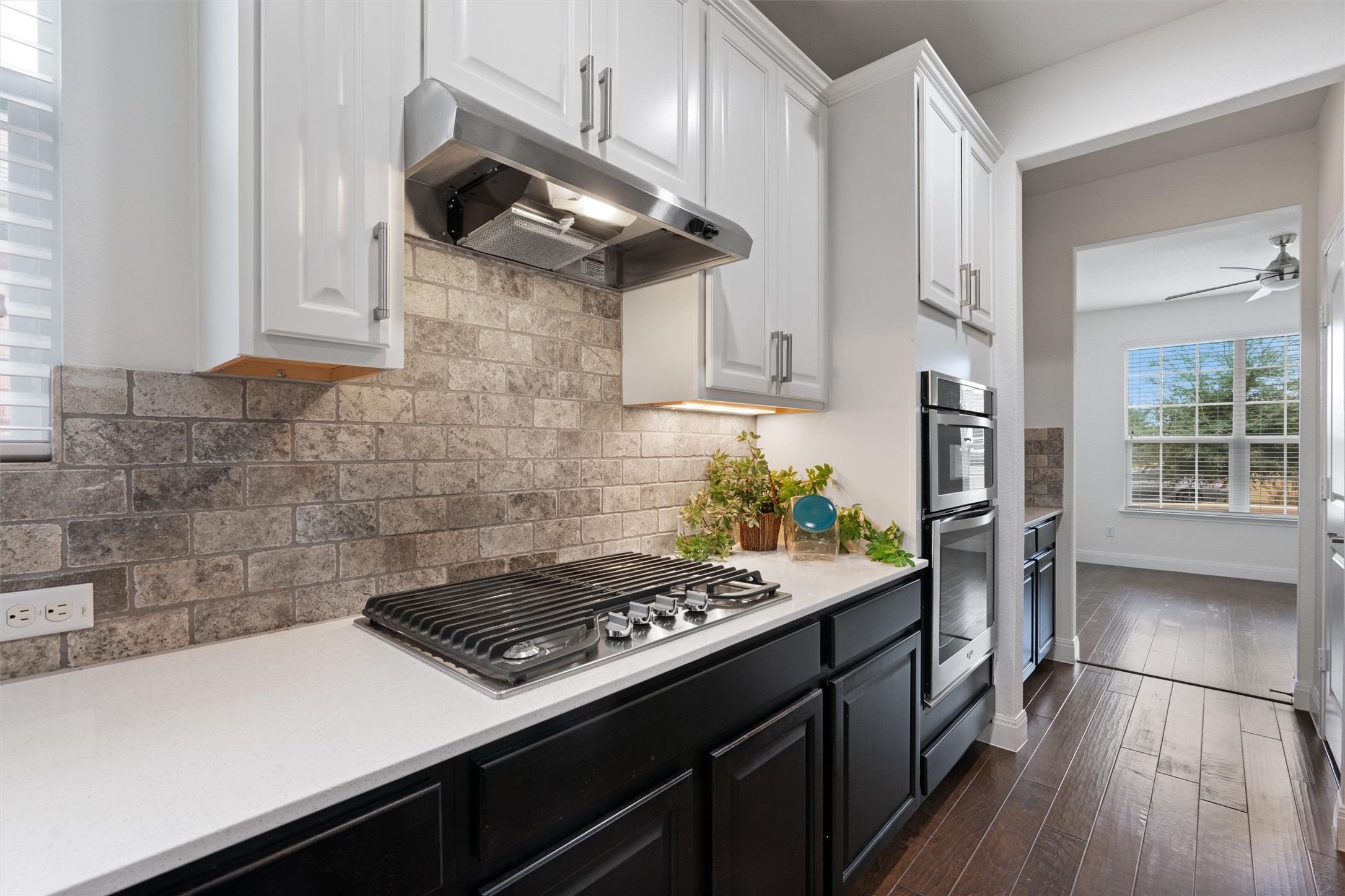706 Kite Ridge Street Georgetown, TX 78633 - Photo 11 of 37 a kitchen with a stove and a wooden floor