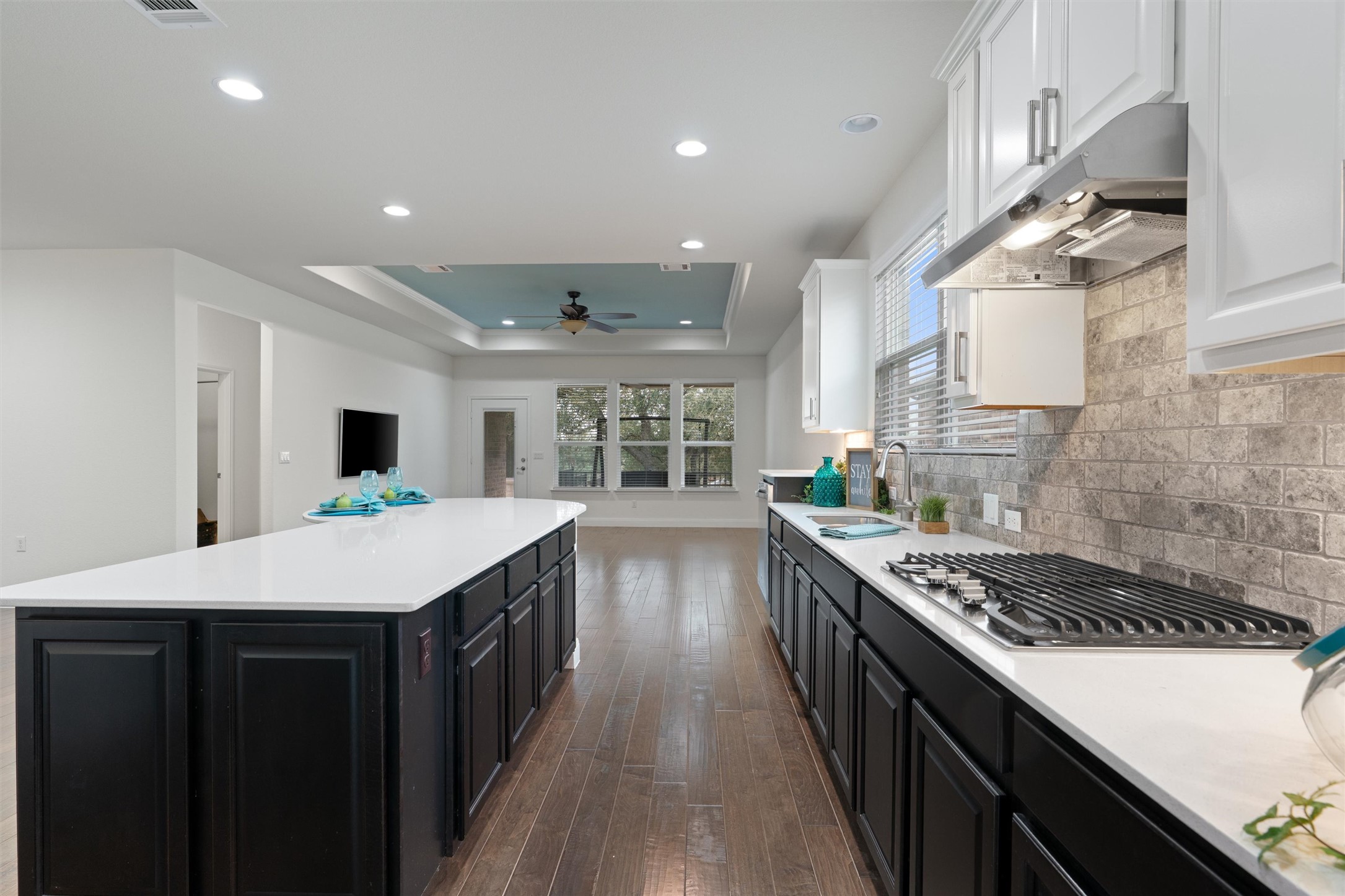 706 Kite Ridge Street Georgetown, TX 78633 - Photo 12 of 37 a kitchen with kitchen island stainless steel appliances a sink a counter top space stove and cabinets