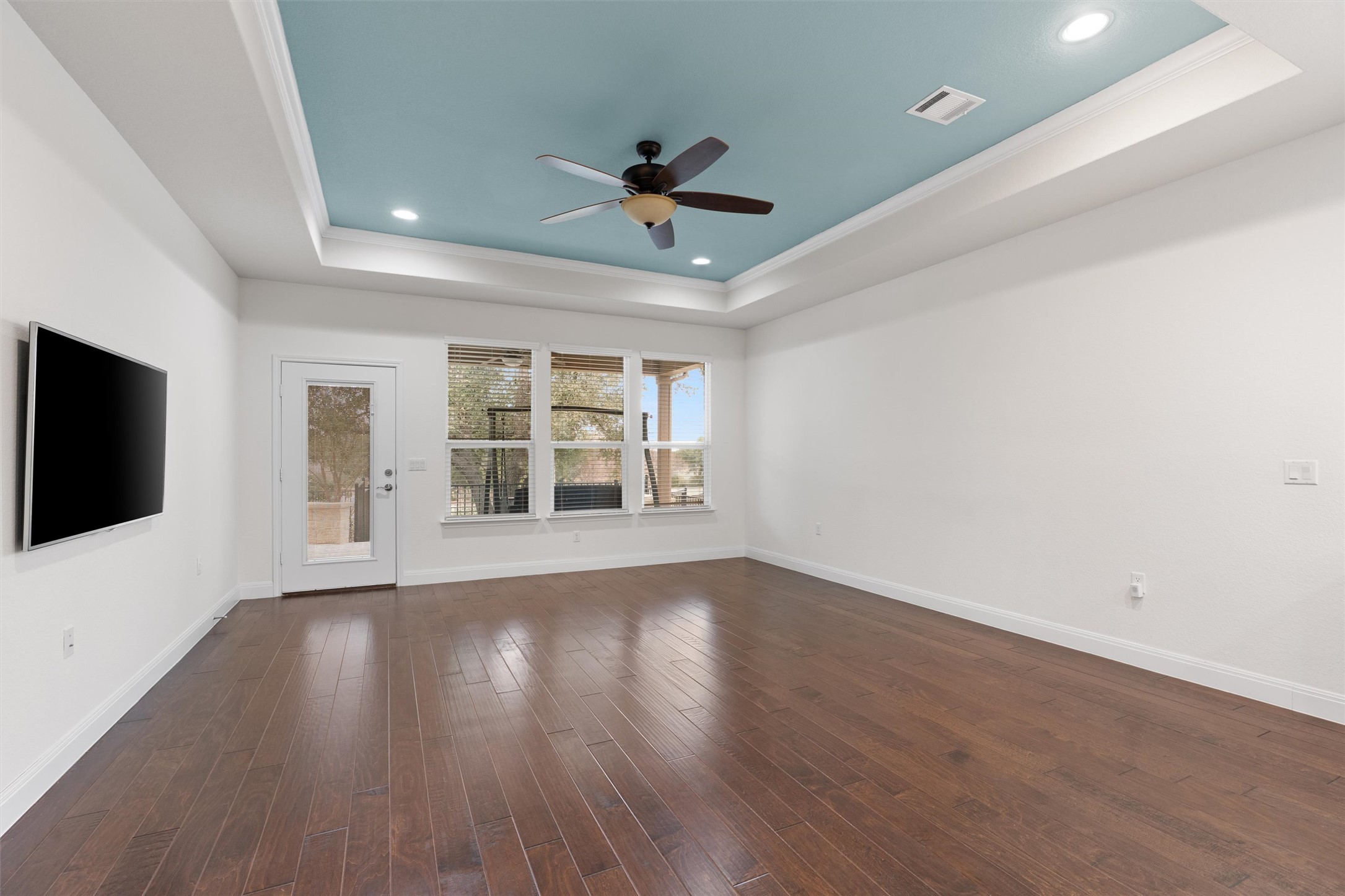 706 Kite Ridge Street Georgetown, TX 78633 - Photo 16 of 37 a view of an empty room with a window and wooden floor