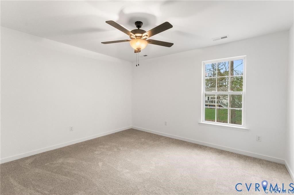 308 Crump Drive Ruther Glen, VA 22546 - Photo 19 of 24 an empty room with window and ceiling fan