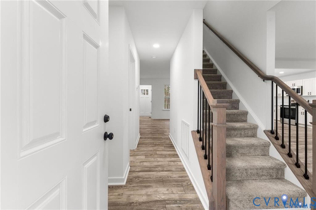 308 Crump Drive Ruther Glen, VA 22546 - Photo 2 of 24 a view of a hallway with wooden floor and stairs