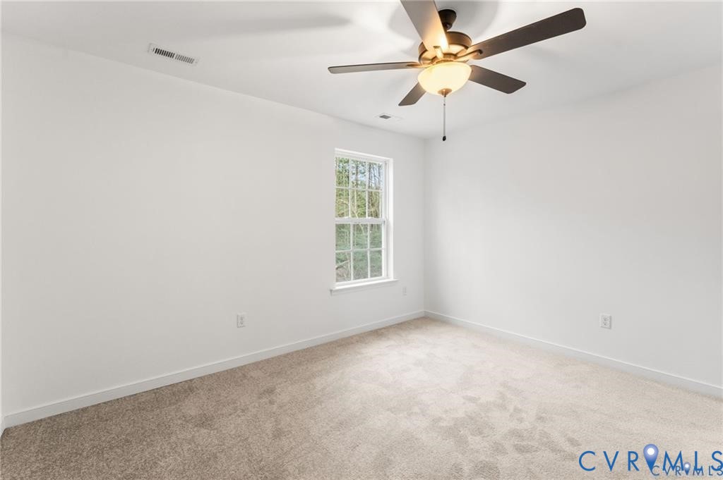 308 Crump Drive Ruther Glen, VA 22546 - Photo 21 of 24 an empty room with a window and a fan
