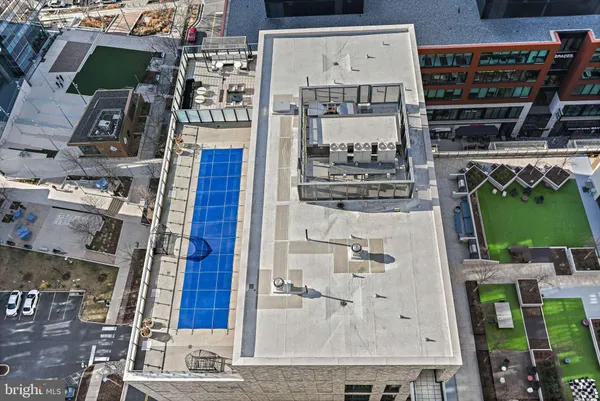 a swimming pool with lawn chairs and wooden fence