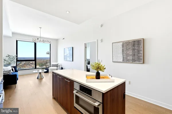 a kitchen with sink stove and refrigerator