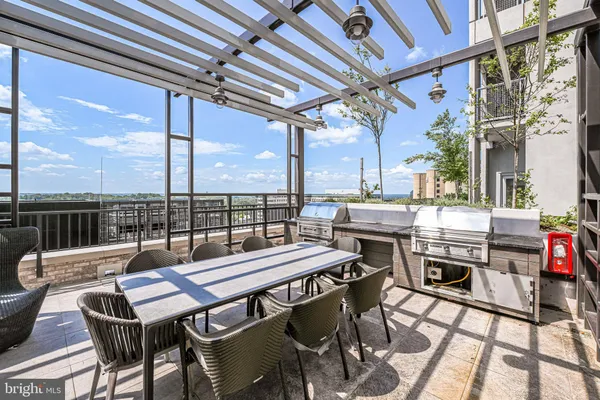 a view of a patio with couches table and chairs and potted plants