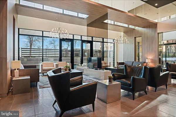 a living room with furniture and large windows
