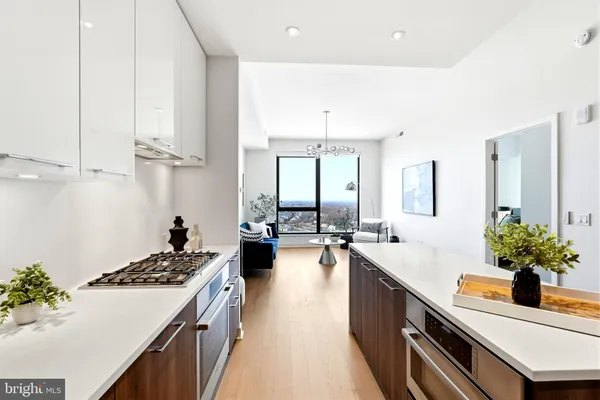 a kitchen with kitchen island a sink dishwasher and stove with wooden floor