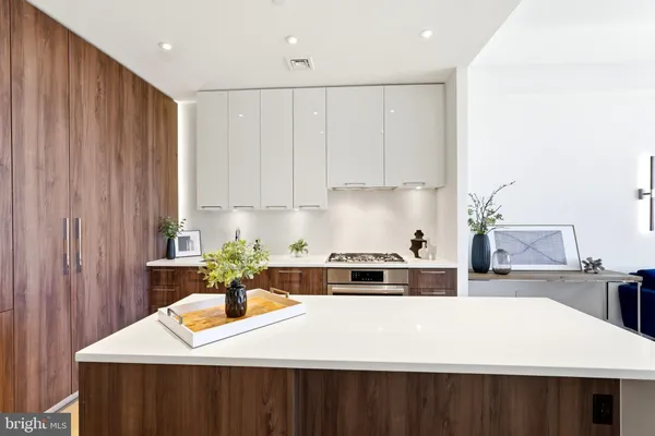a kitchen with a sink a stove and cabinets