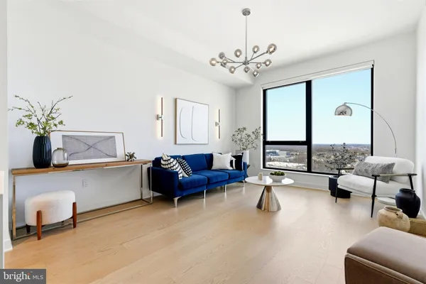 a living room with furniture and floor to ceiling window