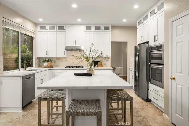a kitchen with a refrigerator a stove a sink and a refrigerator