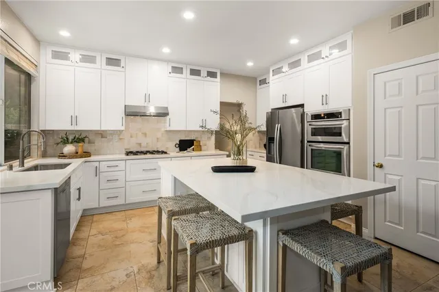 a kitchen with a stove a sink and a counter top space
