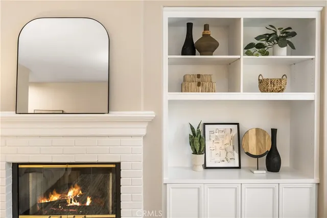a living room with furniture fireplace and a large window
