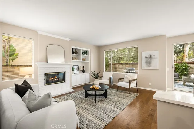 a living room with furniture kitchen view and a potted plant