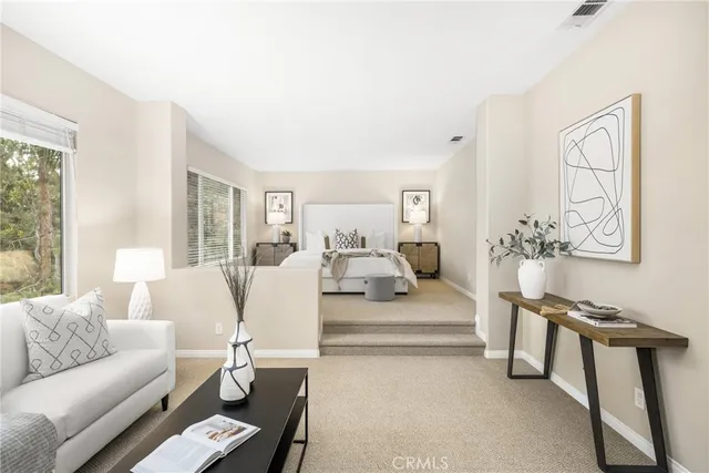 a spacious bedroom with a bed and a large window