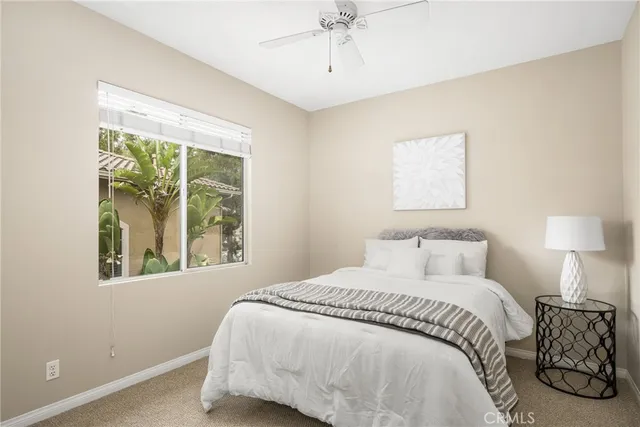 a living room with furniture and potted plants