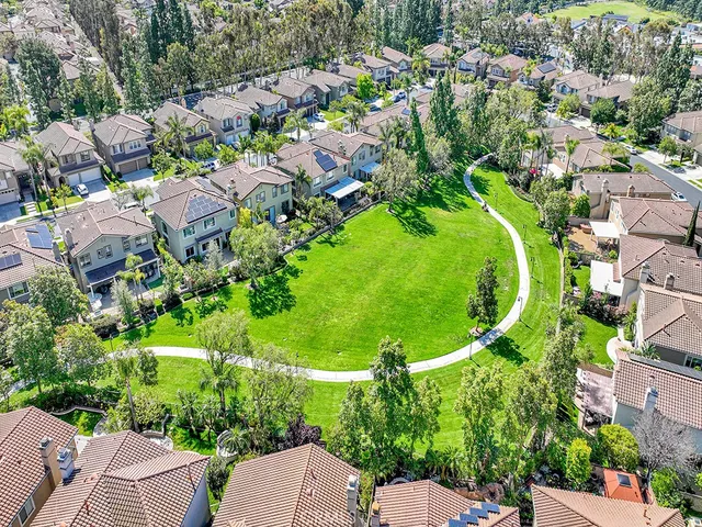 a front view of a house with a yard and potted plants