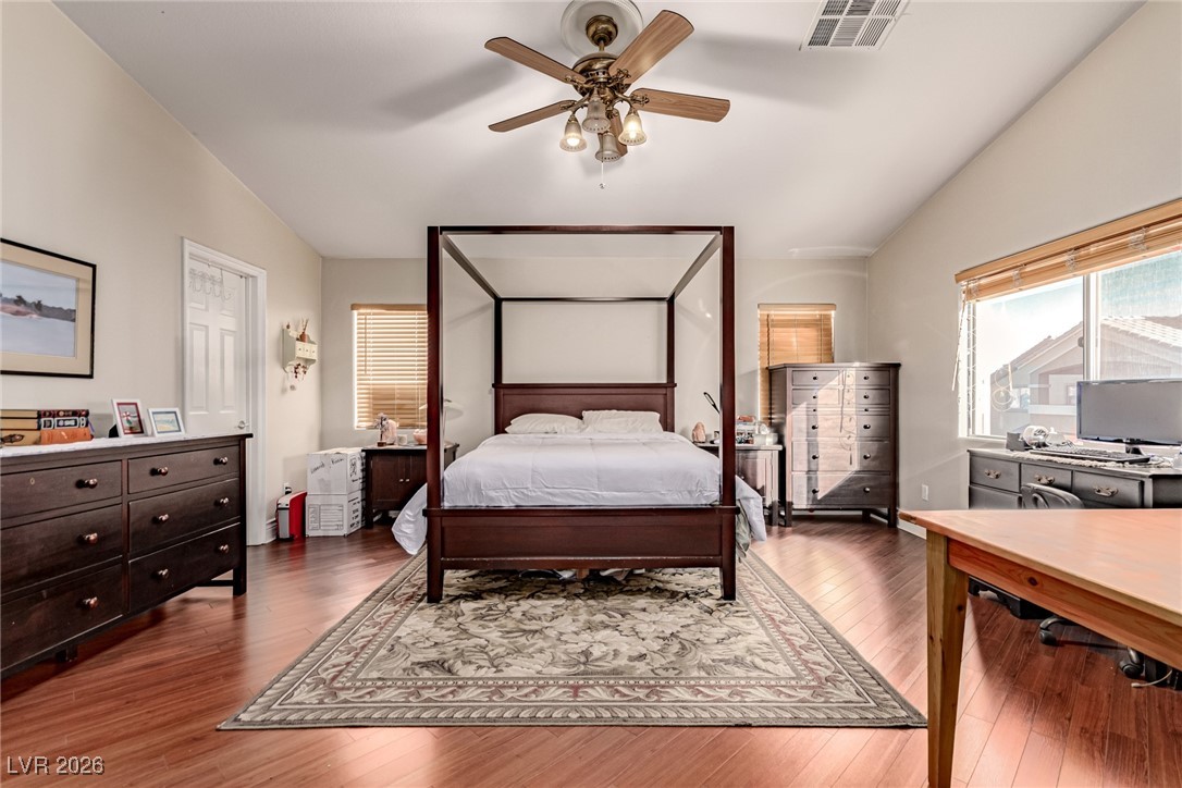 135 Broken Putter Way Las Vegas, NV 89148 - Photo 16 of 40 Bedroom with lofted ceiling, light wood-style flooring, ceiling fan, and an office area