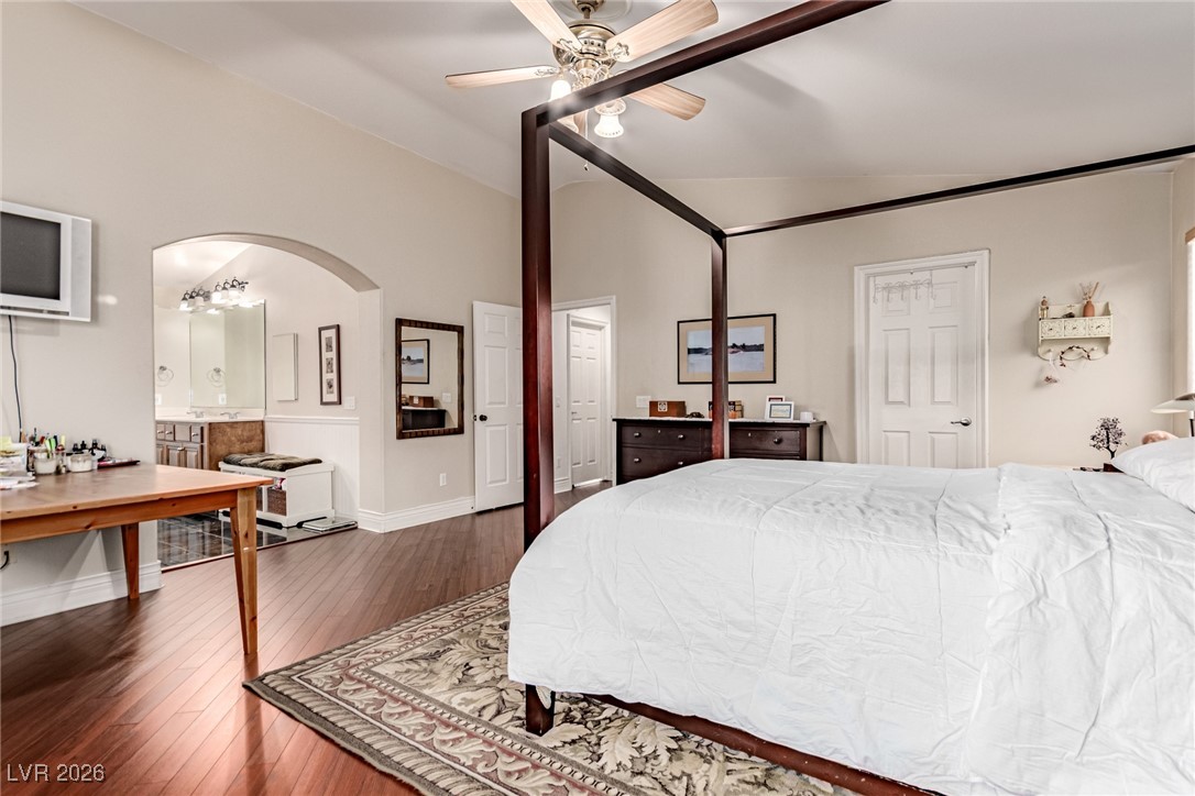 135 Broken Putter Way Las Vegas, NV 89148 - Photo 17 of 40 Bedroom with wood-type flooring, a ceiling fan, arched walkways, and ensuite bath