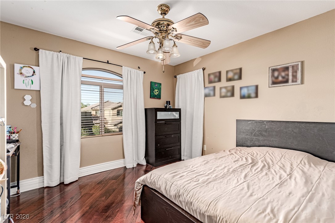 135 Broken Putter Way Las Vegas, NV 89148 - Photo 23 of 40 upstairs Bedroom 4
featuring dark wood finished floors and a ceiling fan