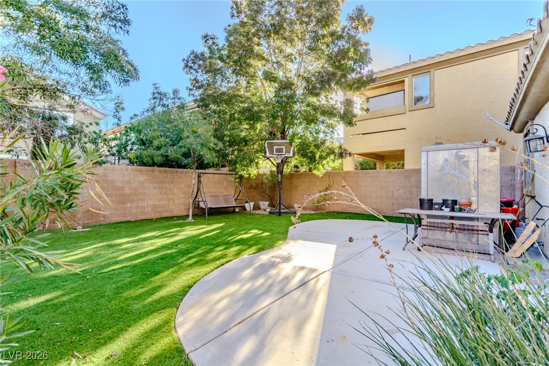 135 Broken Putter Way Las Vegas, NV 89148 - Photo 26 of 40 Fenced backyard featuring a patio area