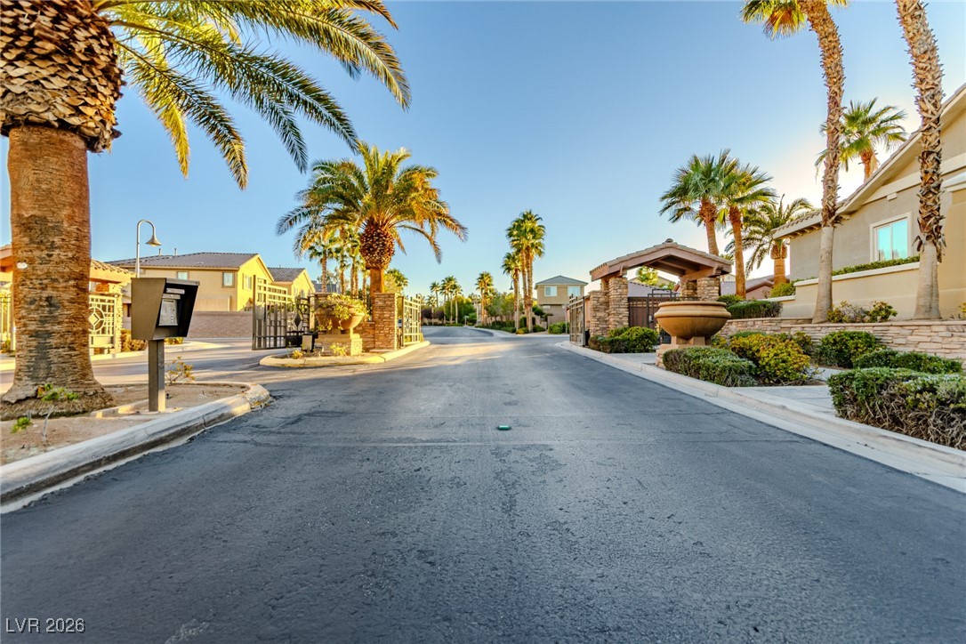 135 Broken Putter Way Las Vegas, NV 89148 - Photo 28 of 40 View of asphalt road with curbs, a residential view, a gated entry, and a gate