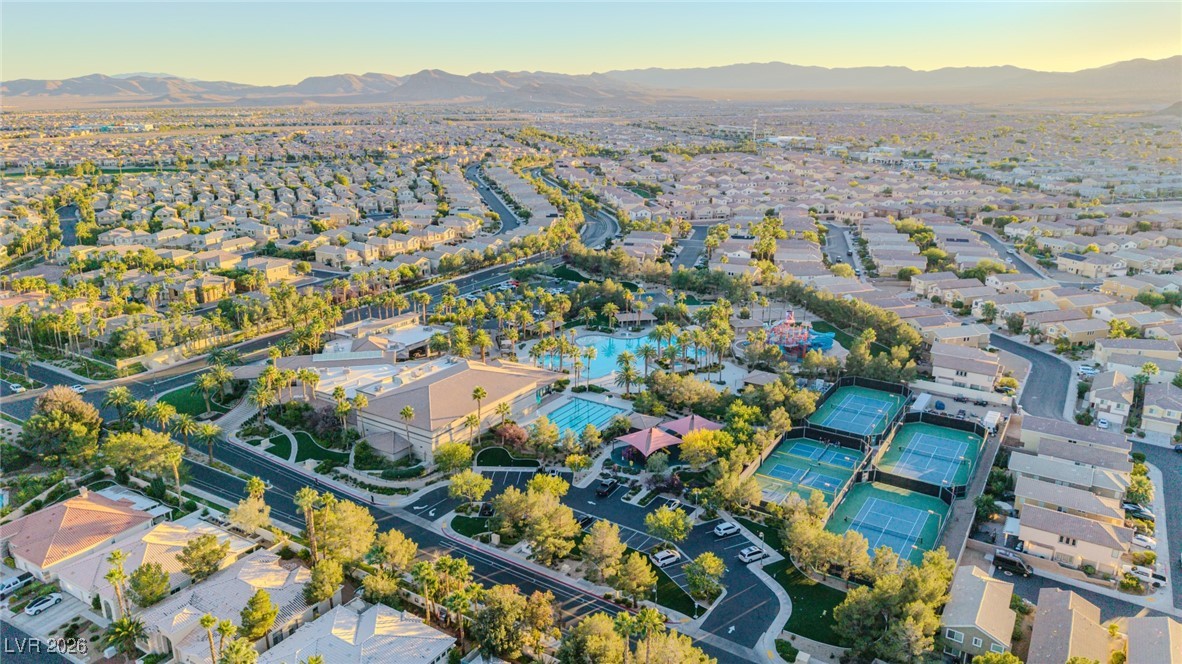 135 Broken Putter Way Las Vegas, NV 89148 - Photo 35 of 40 Aerial view of property and surrounding area with nearby suburban area and a mountain backdrop