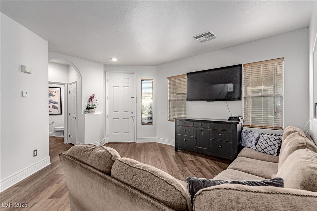 135 Broken Putter Way Las Vegas, NV 89148 - Photo 4 of 40 Living area with wood finished floors, arched walkways, and recessed lighting