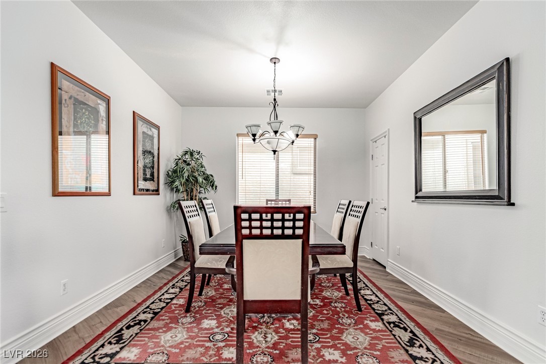 135 Broken Putter Way Las Vegas, NV 89148 - Photo 8 of 40 Dining space with plenty of natural light, a chandelier, and wood finished floors