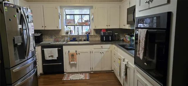 a kitchen with appliances and cabinets