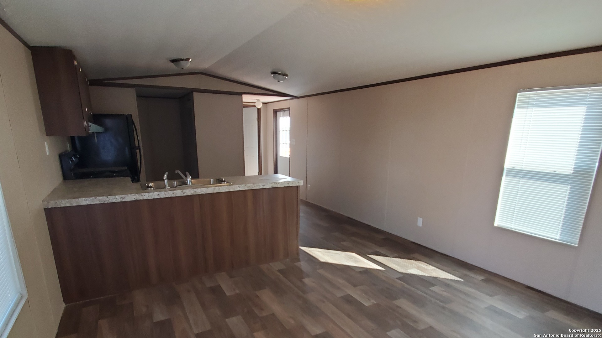 7380 Pittman Road, Unit 3 Adkins, TX 78101 - Photo 3 of 10 a view of an empty room with wooden floor and a window