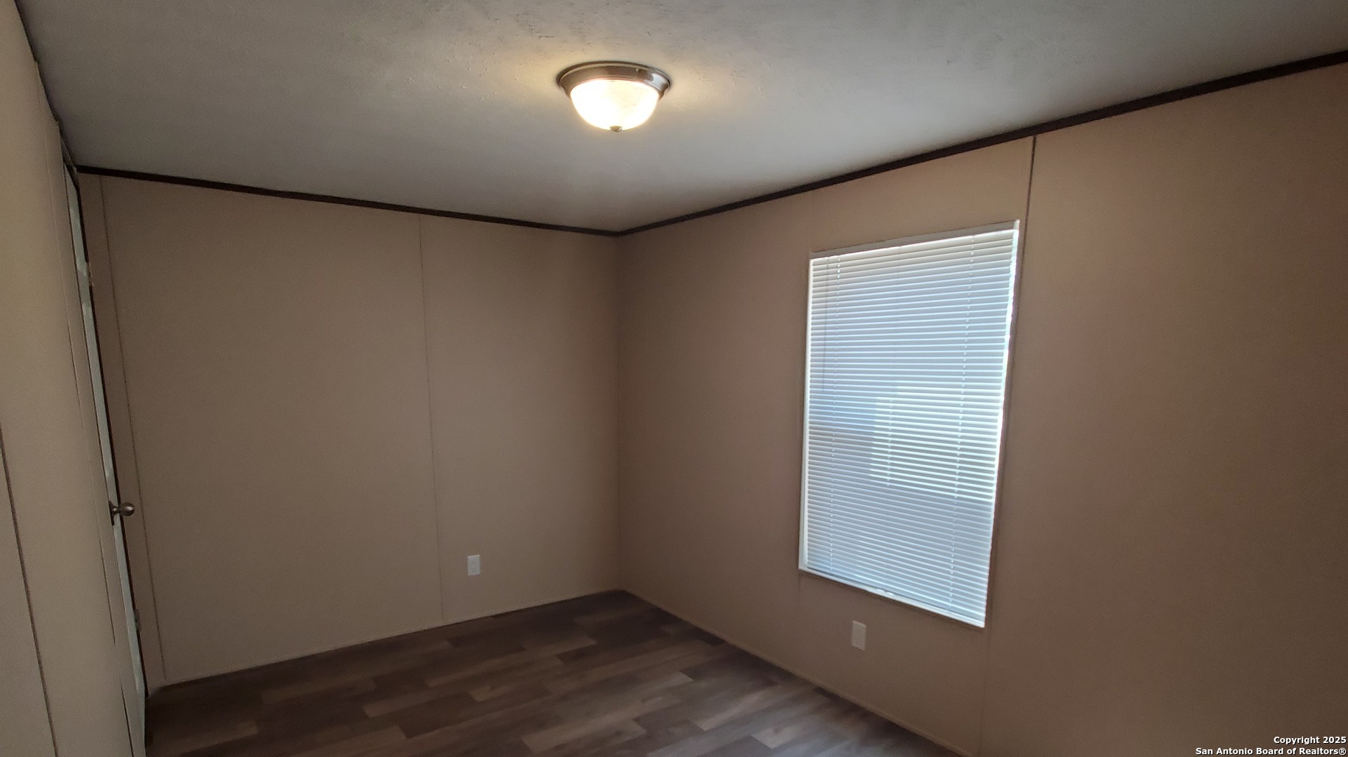7380 Pittman Road, Unit 3 Adkins, TX 78101 - Photo 7 of 10 an empty room with wooden floor and windows