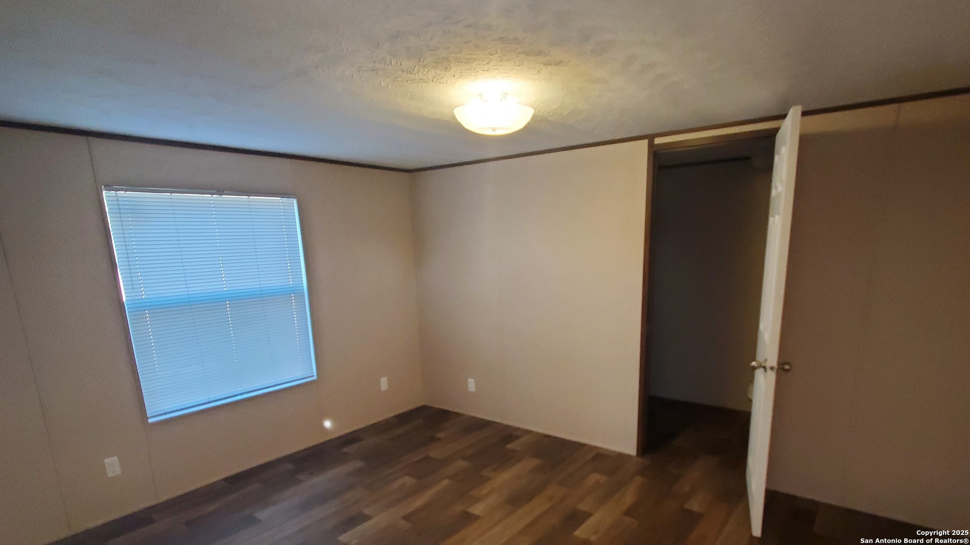 7380 Pittman Road, Unit 3 Adkins, TX 78101 - Photo 8 of 10 a view of an empty room with wooden floor and a window
