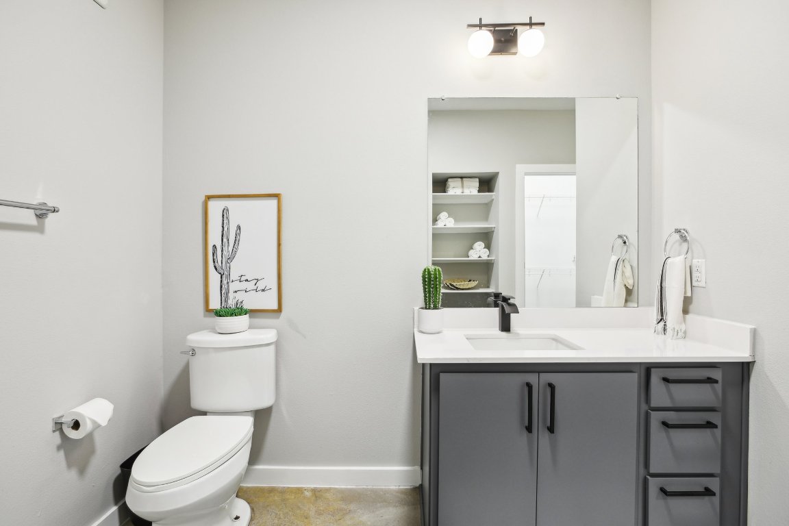 2505 Thornton Road, Unit 1107 Austin, TX 78704 - Photo 16 of 32 a bathroom with a toilet sink vanity and mirror