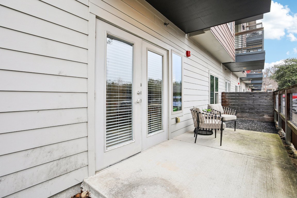 2505 Thornton Road, Unit 1107 Austin, TX 78704 - Photo 20 of 32 a roof deck with table and chairs and wooden floor