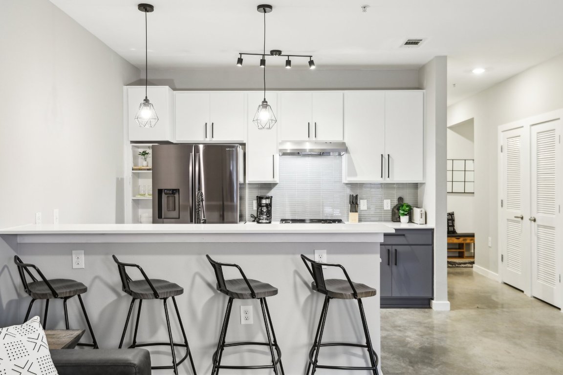 2505 Thornton Road, Unit 1107 Austin, TX 78704 - Photo 7 of 32 a kitchen with stainless steel appliances granite countertop a refrigerator and microwave