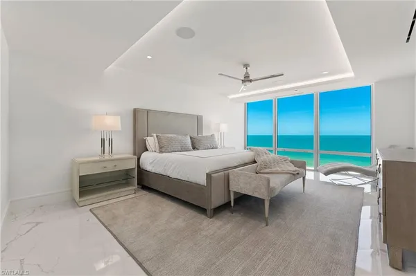 a bedroom with a bed and a ceiling fan